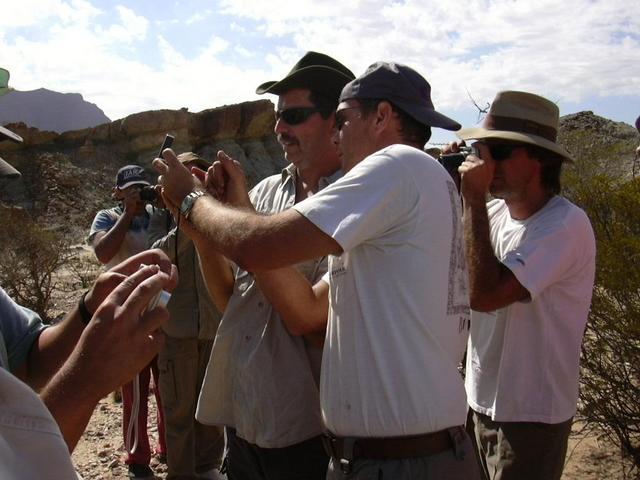 Martin taking pictures of the precise location. Marcelo and Fernando holding GPSs