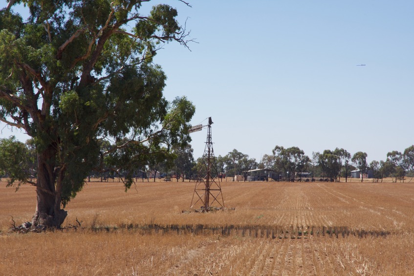 A close-up view of a well and farm buildings to the north of the point