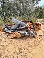 #8: Rusted abandoned car, with some new trash on top