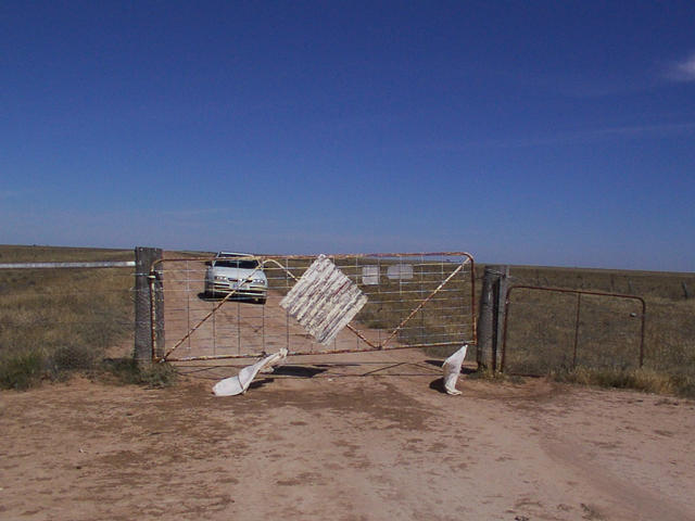 A gate in the middle of the road next to the confluence