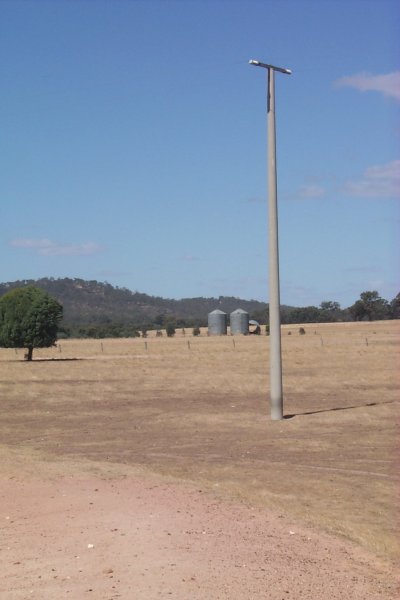 To the south is a utility line and a pair of silos