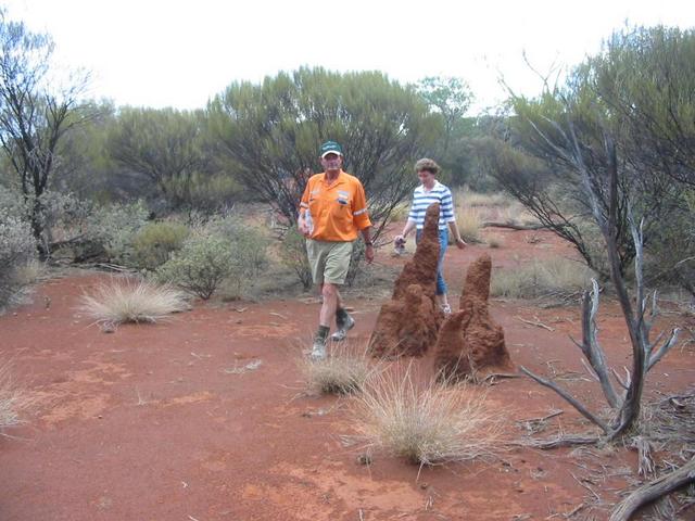 Alasdair and Sue walking past ant hills