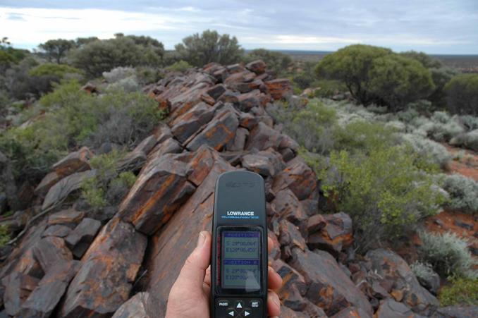 Hill summit showing angled, iron rich strata