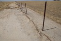 #5: The confluence point lies beside this north-south fence, in farmland