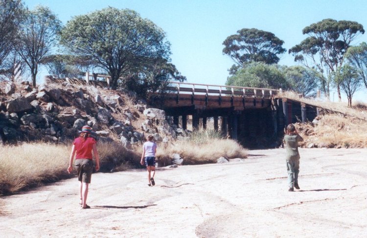 Sarah, Peter and Maddy walking along the river bed to the bridge