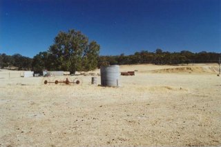 #1: Looking north with redundant farm implements and dam on the right.