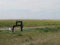 #7: A few meters to the North of the confluence is oil industry equipment.  South Saskatchewan River valley can be seen in the distance.