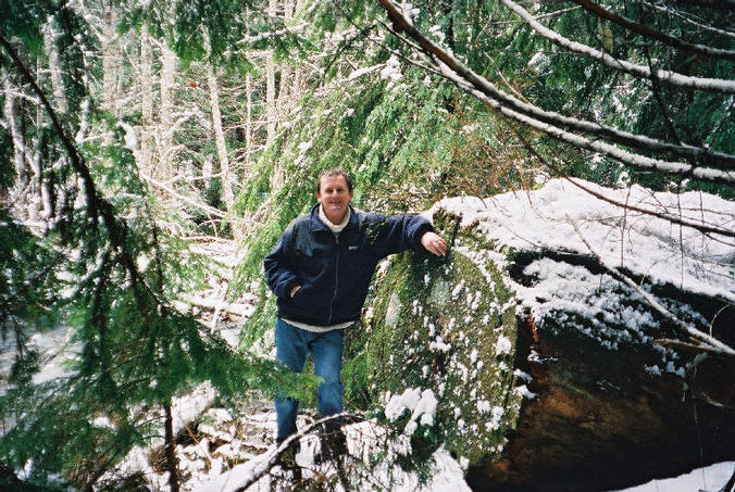 Leaning against a big log