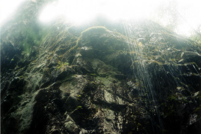 one of the many waterfalls buried deep behind the trees.