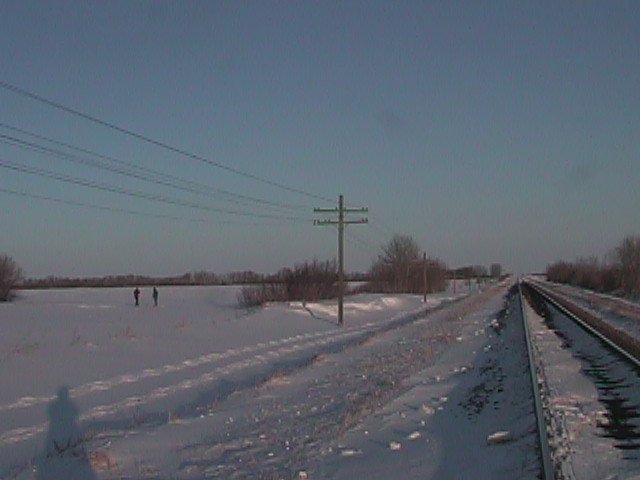 View of Area with Two Figures Standing at Confluence