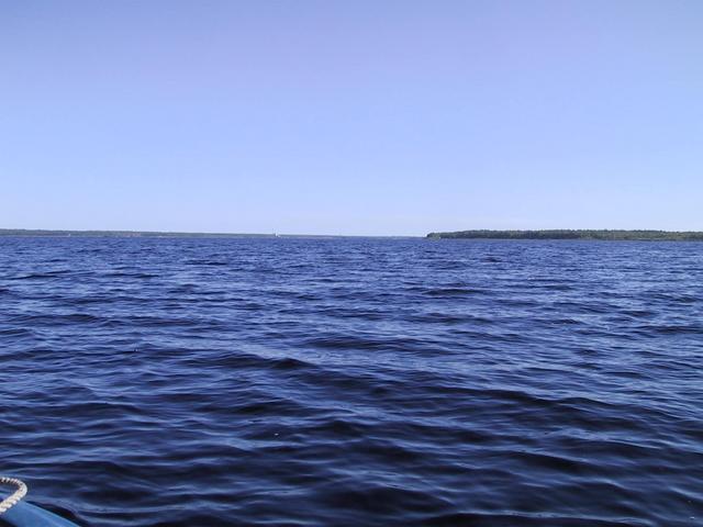 At 46N 66W. On the confluence point, looking North.  Cox Point is to the right.  Chimney in center is a coal-fired electric power plant.