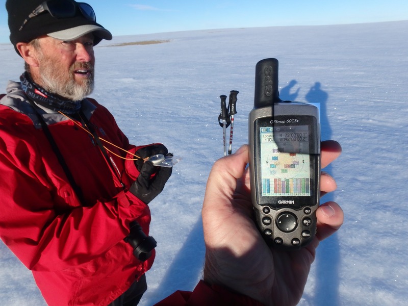 A picture of John Dunn at the confluence. (I had to lighten the GPS screen as it was in deep shadow.)