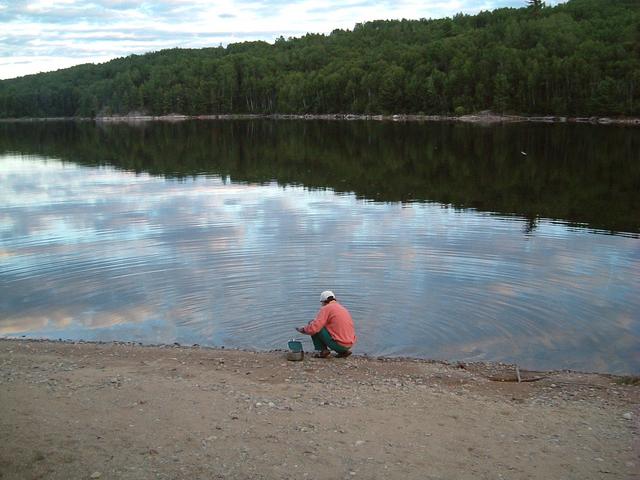 On a still lake, even washing dishes can be picturesque