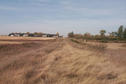 #5: Looking west along the border with the US Customs buildings in the background.