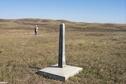 #5: View northeast showing border monument and Alan standing at the confluence.