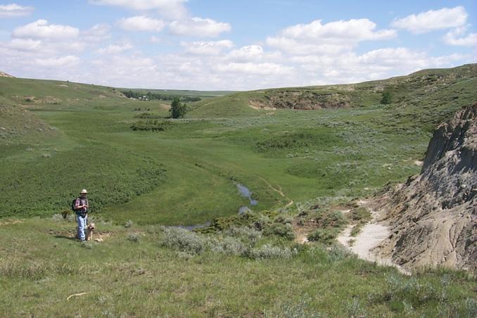 View NE with Alan and Max at the confluence.  Ranch can be seen in the distance.