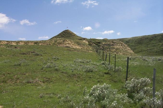 The view east along the border.  Canadian flag flies on top of Peak Butte.