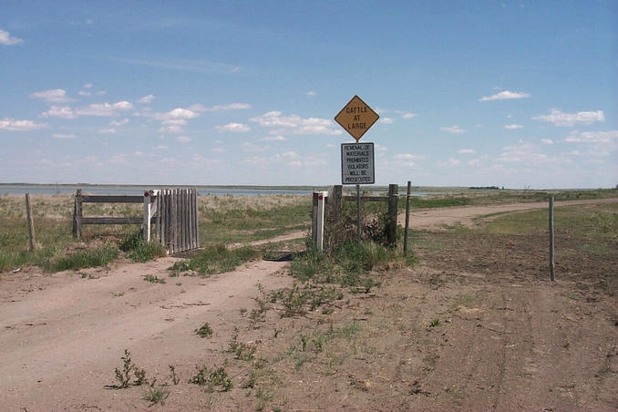 Texas cattle gate at entrances to pasture. Old Wives Lake seen on left in background.