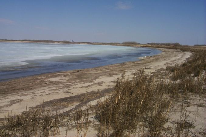 The ice melting on Clair Lake, 3.9 km from the confluence.  The town of Clair grain elevator can be seen on the horizon.