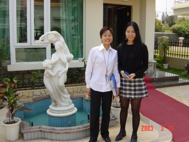 Salesgirl May and Emily posing in front of the show unit.