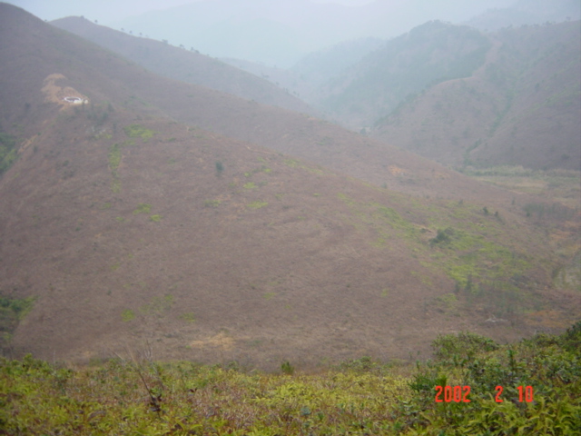 Confluence is in hills on right side of valley; hillside grave on left