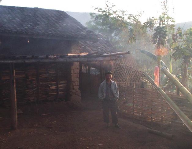 Farmer who took me in with house in background.