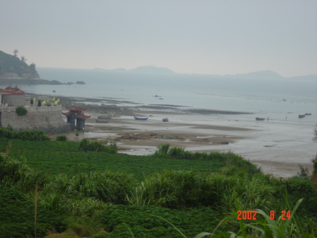 Bluff overlooking the bay, with the confluence in the water just beyond the small rocky peninsular jutting out above the temple.