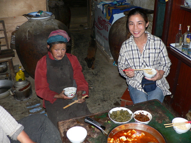 Ah Feng and the landlord's mother enjoying a meal of spicy hot bean curd and pork.