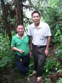 #6: Targ's motorcyclist (holding the GPS) and another local at the confluence point, on a steep, densely forested hillside.