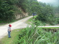 #4: Ah Feng at the Kēngdòng turnoff, as the Lípíng bus disappears down the main road.