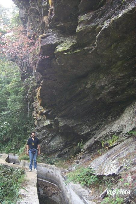 Tony on aqueduct, dwarfed by overhanging rocks