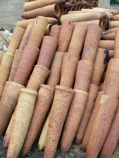 Mysterious cones in Hèzhāng County, used for everything from fences to retaining walls to flowerpots to roof ornaments, even as supports for satellite dishes.