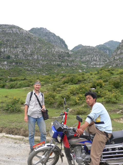 Targ and our motorcyclist, with the confluence 1 km north, amongst the hills off to the right.