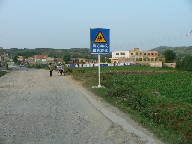 View of the school looking back down the road towards Qiánxī, with the confluence 420 metres SE, off to the right.