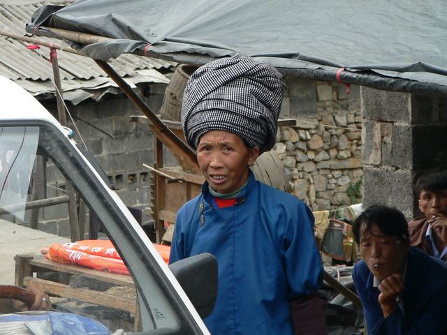 Woman in minority nationality costume, with large headgear.