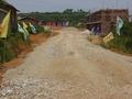 #3: Gravel road to construction site, with confluence on top of hill behind