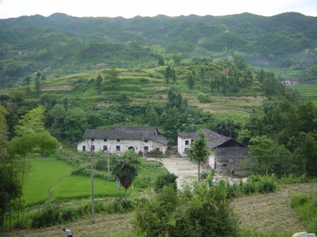 Confluence located in hills beyond farmhouses