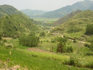 #1: Facing east-northeast, with farmhouse in centre, main road in distance, and side road on right