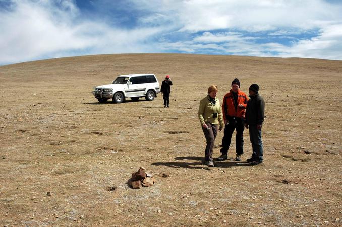 Leslie, Mike, and Buchong the guide at the confluence, with Mr Wei the driver approaching after he decided he could follow in the vehicle.  Note the pre-existing cairn.