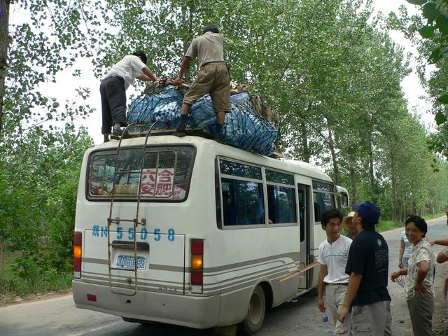 Xiao Xu looks on as rooftop load is rescued.