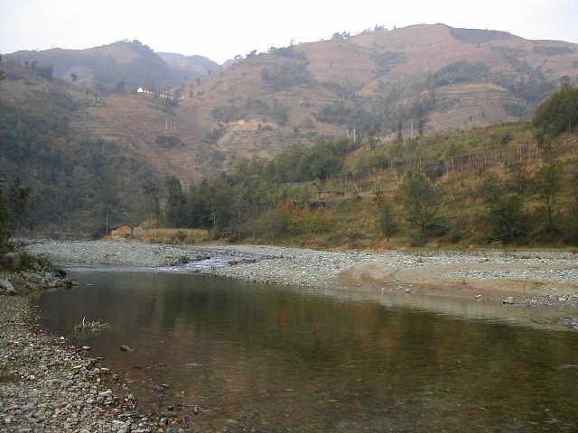 The area with the confluence located across the river on the low hill