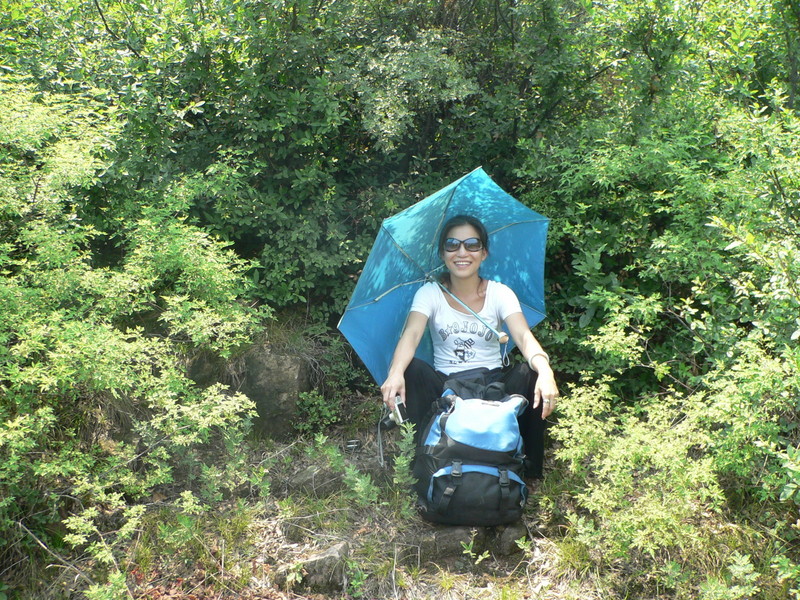 Ah Feng sheltering from the sun in the tiny clearing at the confluence