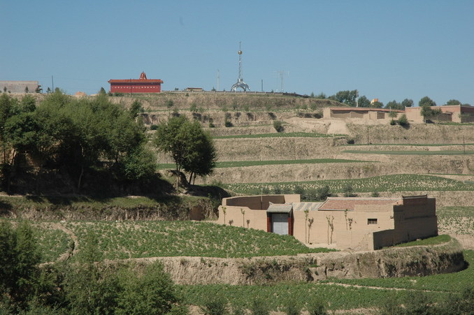 A distant view of the monument tower from the nearby village