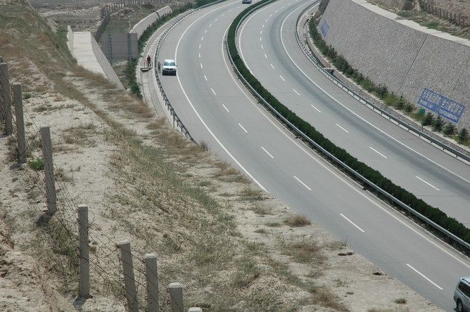 The waiting car parked on the shoulder of the expressway