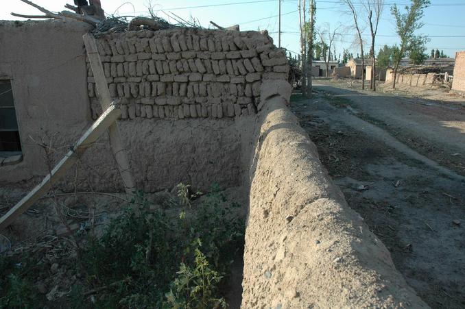 South view - the mud wall and the street