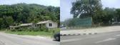 #7: Houses a few kilometers away with rock outcroppings in the background; a typical sign along the road leaving Habana.