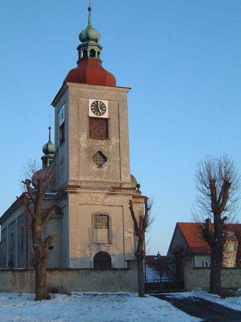 The last rays of the setting sun on the church at the heart of the village of Uhersko.