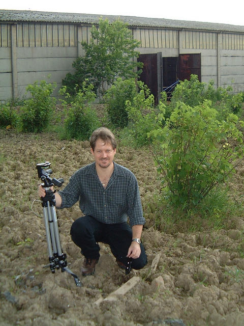 A view to the south west with Mark Pautz crouching over the confluence with his faithful tripod.