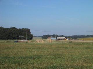 #1: The spot of the confluence, looking west (see oil well)