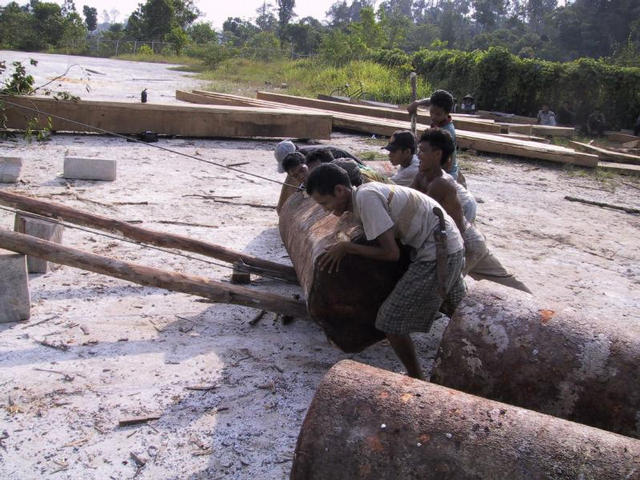 Logging crew loading truck.